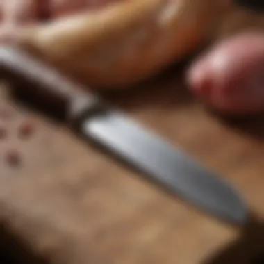 A close-up of a butcher's knife next to high-quality poultry