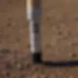 Close-up of a marking paint stick on a farm field